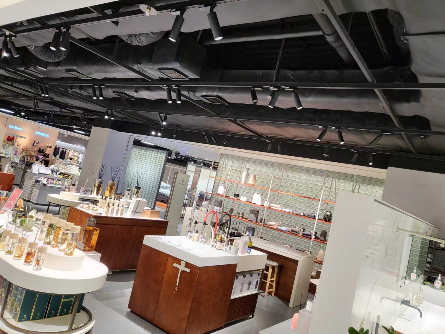 modern department store retail lighting in Korea with LED track lights highlighting product displays