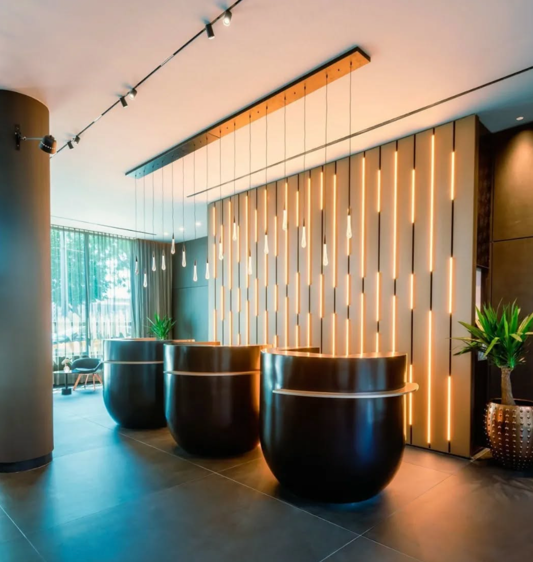 Hotel lobby lighting with decorative pendant lights and track lighting