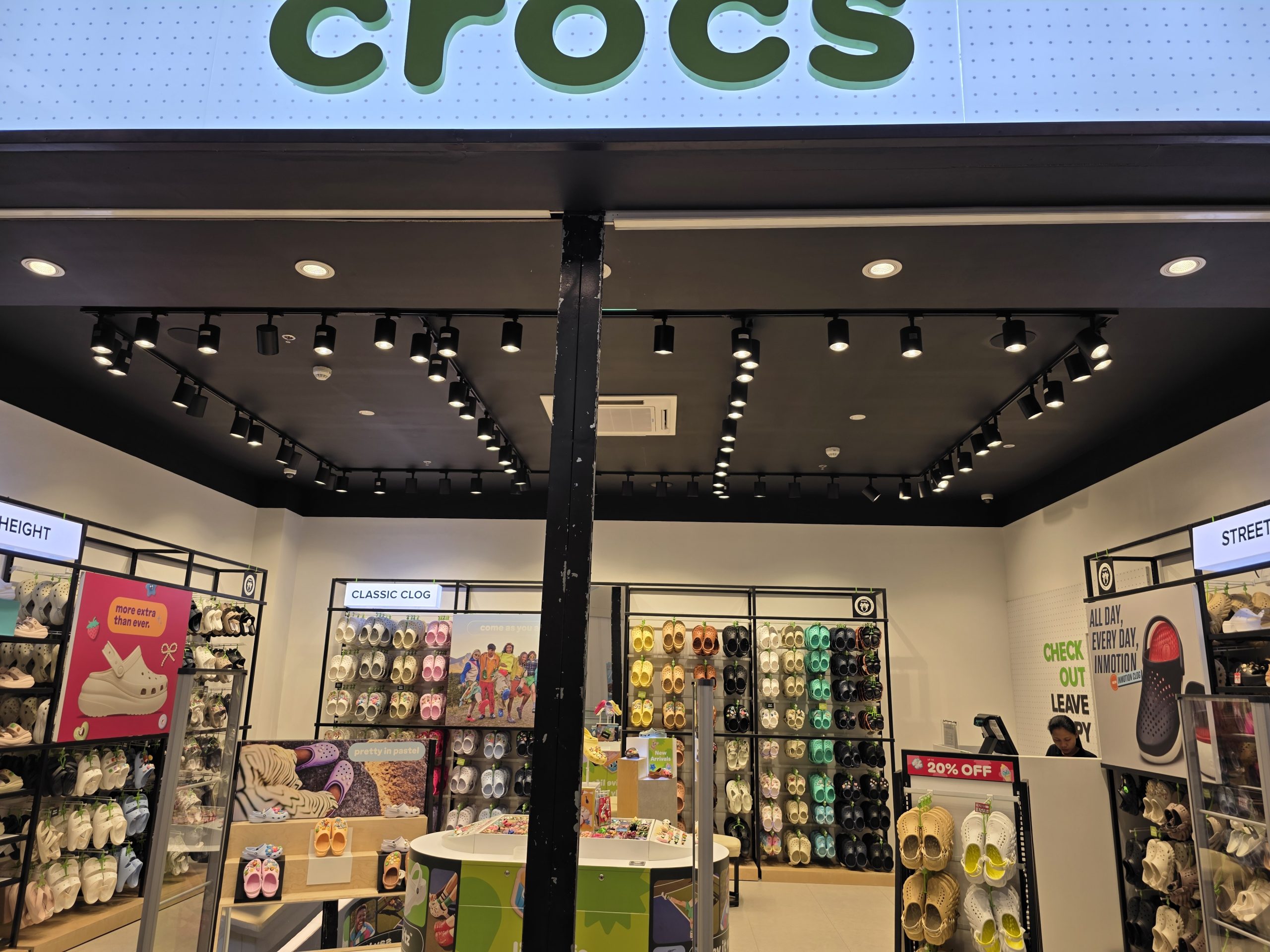 Retail interior lighting with track lights for footwear store