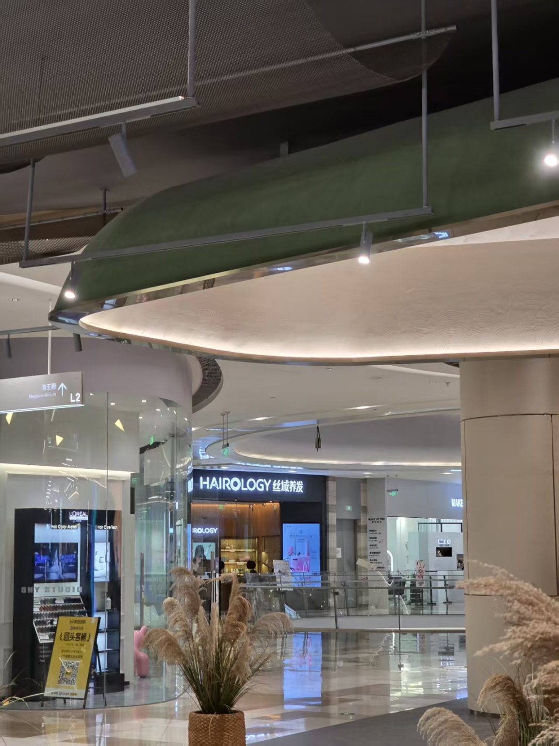 Commercial corridor lighting at Guangzhou Baiyun Airport using suspended LED track spotlights and architectural ceiling lighting.