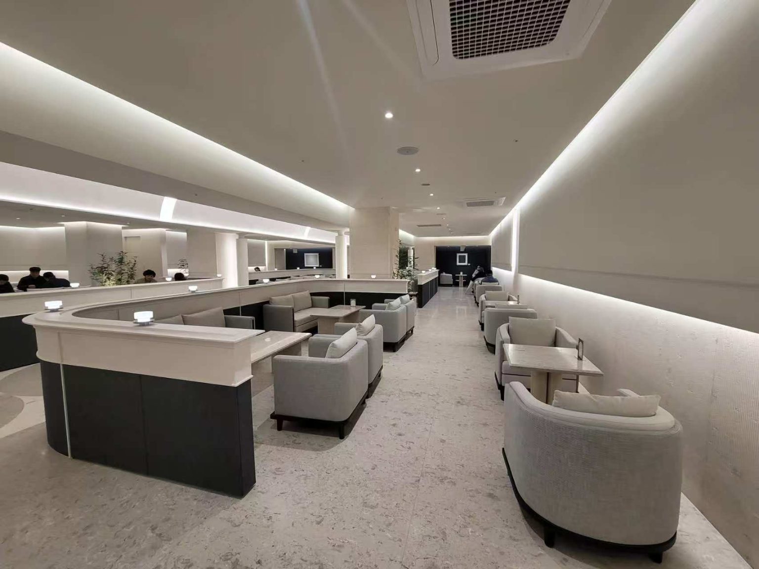 Korea residential interior with minimalist indirect LED strip lighting integrated into ceiling coves and wall architectural details