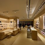 Magnetic track lighting system in modern retail store with adjustable spotlights