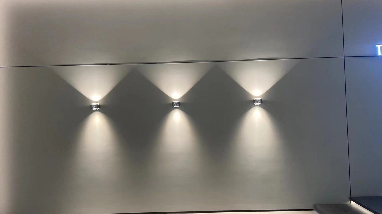 Modern residential wall lighting design with decorative LED wall lights creating architectural light patterns.