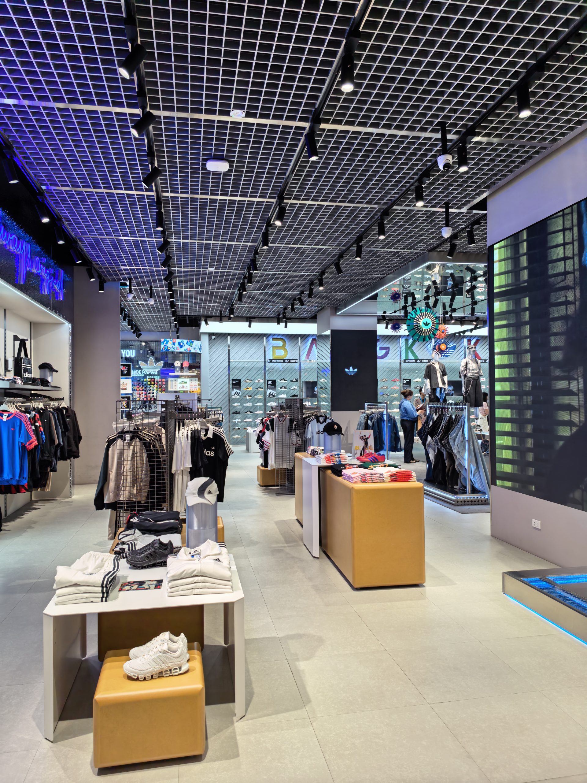 Sports retail store lighting with adjustable track spotlights in Thailand shopping mall